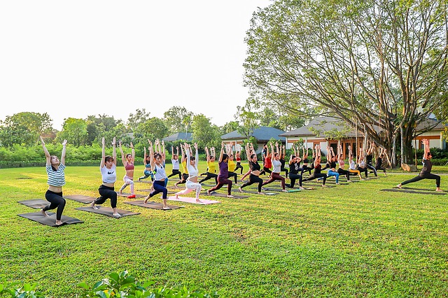 Benefits of Exercise on Parkinson's Disease - a photo of a Yoga Class outdoors