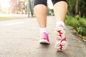 Aerobic Exercise for Parkinson's - photo of a pair of legs for a person walking with pink sneakers